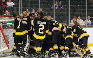 Warroad players knocked over the net and each other as they celebrated their third straight Class 1A title Saturday.