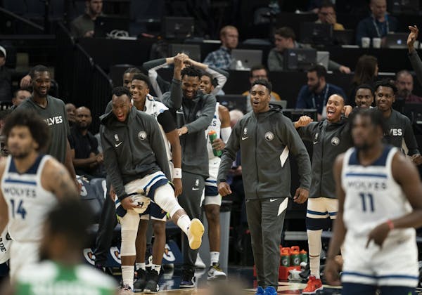 The Timberwolves bench reacted to a fourth quarter basket by guard Jordan McLaughlin.