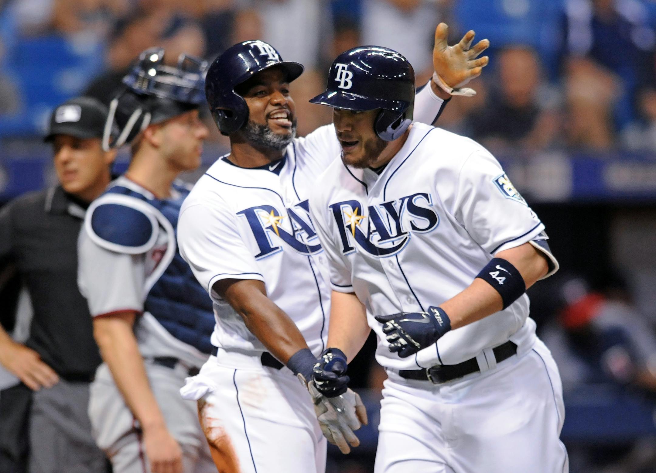 Tampa Bay Rays' Denard Span, center, congratulates C.J. Cron, right, after scoring on Cron's two-run home run off Minnesota Twins reliever Gabriel Moya during the seventh inning of a baseball game Saturday, April 21, 2018, in St. Petersburg, Fla. (AP Photo/Steve Nesius)