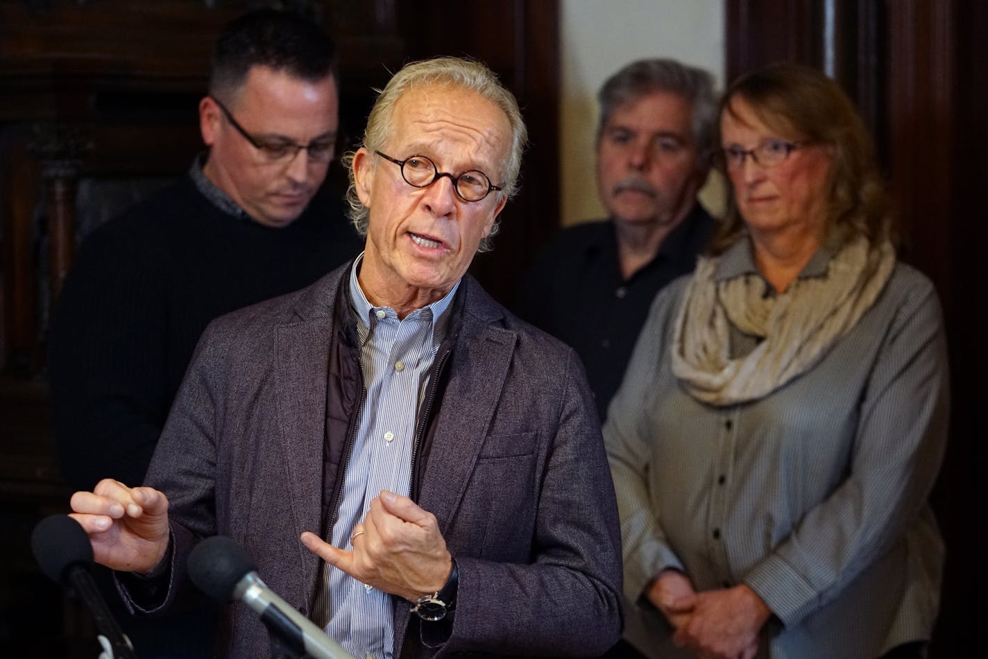 Jeff Anderson holds a news conference about judge's rejection of both the church's and victims' plans for addressing the millions of dollars of clergy sex abuse claims. Behind him are abuse victims, l to r, Jim Keenan, Ann Fern, far right. Jim Fern, center is the husband of Ann but not a victim.