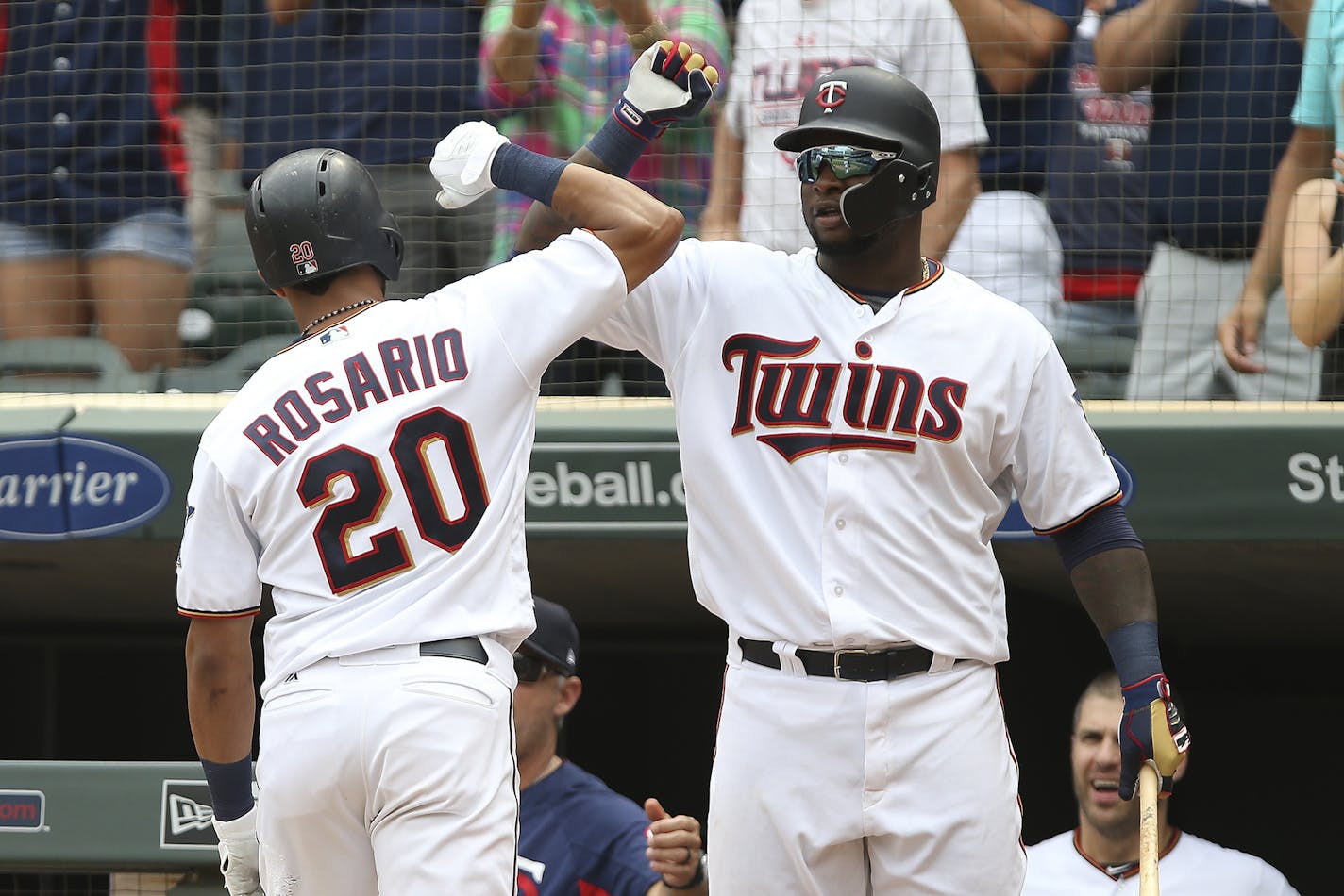 Minnesota Twins' Eddie Rosario celebrates with teammate Miguel Sano after hitting a home run against the Detroit Tigers in the eighth inning of a baseball game Sunday Aug. 19, 2018, in Minneapolis. (AP Photo/Stacy Bengs)