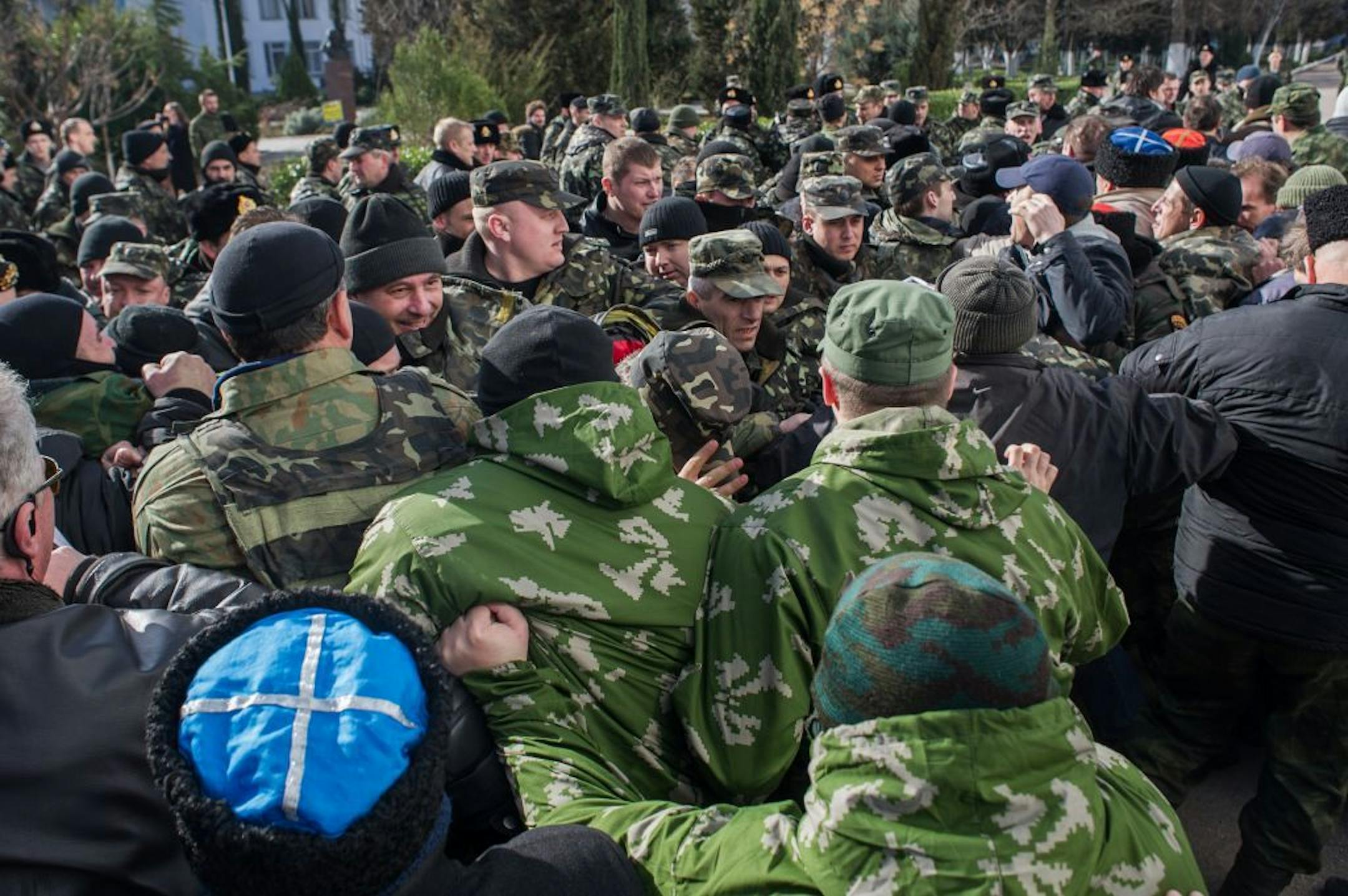 Crimean self-defense forces scuffle with Ukrainian servicemen outside the Ukrainian Navy headquarters in Sevastopol, Crimea, Wednesday, March 19, 2014.