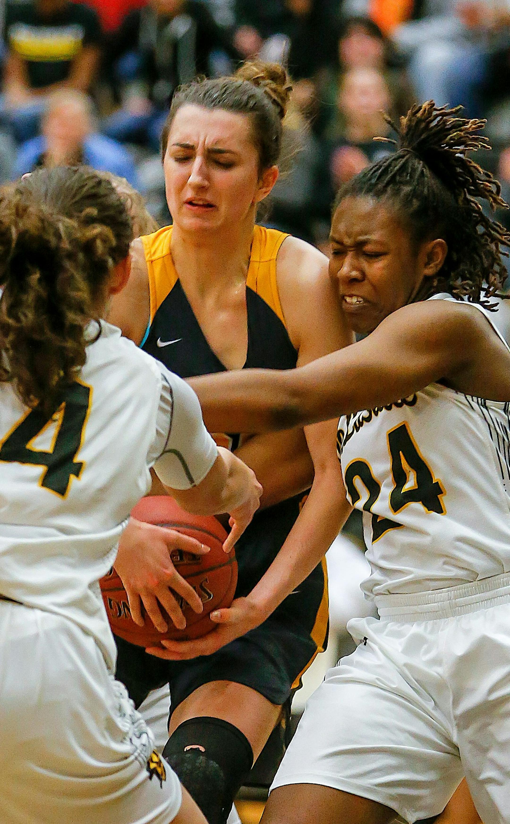 Elaina Jones (24) takes the ball from Mahtomedi's Emma Grothaus. DeLaSalle held Grothaus, the Zephyrs' leading scorer, to five first-half points. Mahtomedi led 19-17 at the half. Class 3A Section 4 girls basketball final: DeLaSalle vs. Mahtomedi at East Ridge HS, 3-8-18. Photo by Mark Hvidsten, SportsEngine
