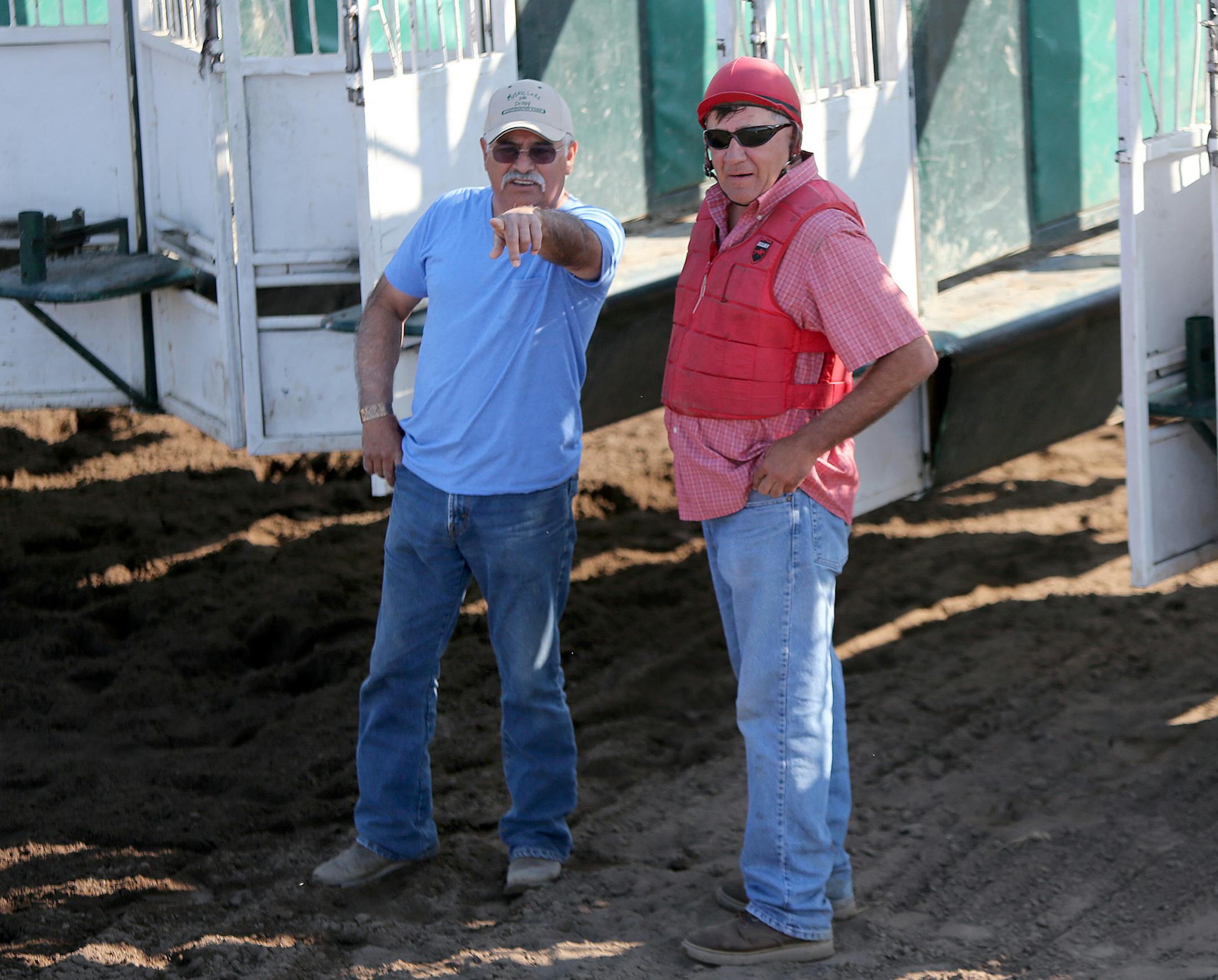 Larry Divila, left, and Larry Belkham, right, who has worked for 23 years at the track worked the starting barriers at Canterbury Park, Wednesday, July 3, 2013 in Shakopee, MN. (ELIZABETH FLORES/STAR TRIBUNE) ELIZABETH FLORES &#x2022; eflores@startribune.com