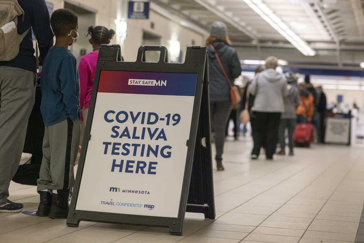 People stood in line to make their way through the new saliva COVID-19 testing site at the Minneapolis-St. Paul International Airport on Nov. 12, 2020.