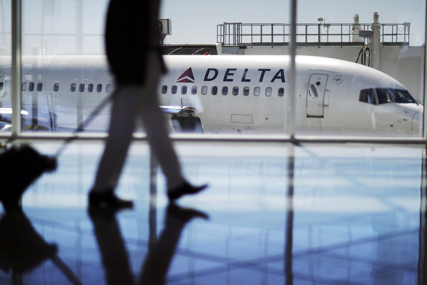 A Delta Air Lines jet sits at a gate at Hartsfield-Jackson Atlanta International Airport in Atlanta.