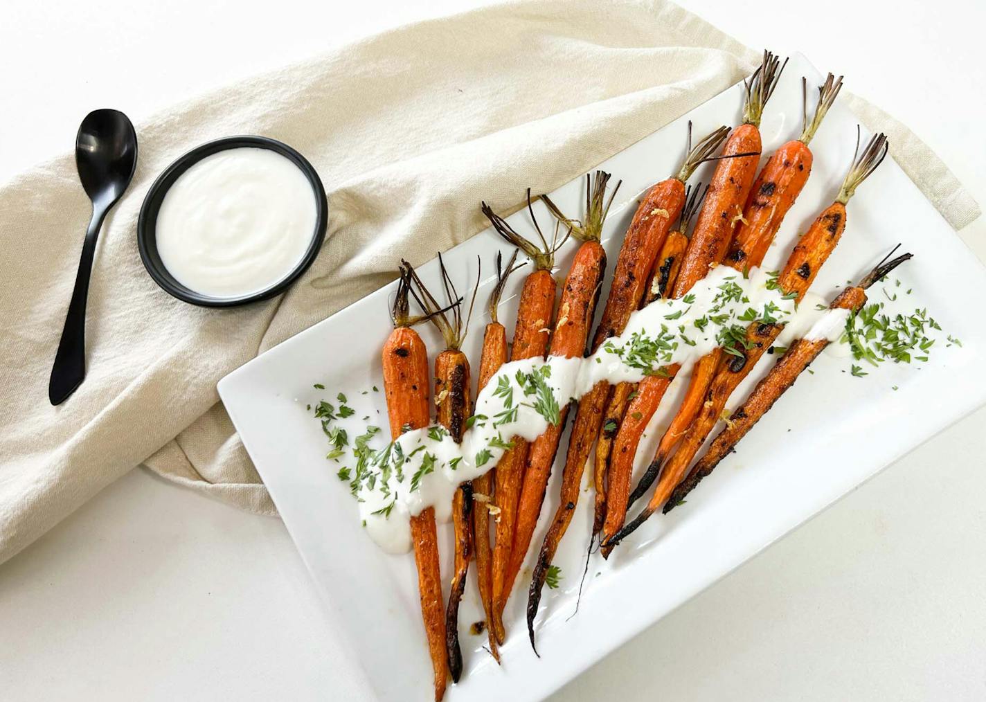 Top roasted young carrots with a yogurt sauce for a tasty (and pretty) side dish. Photo and recipe by Robin Asbell, Special to the Star Tribune