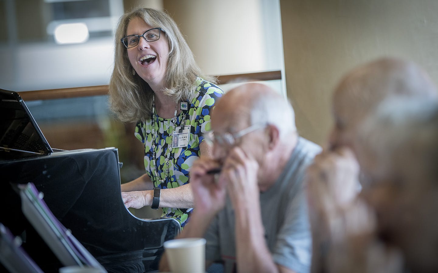 Dawn McDougal Miller played the piano as she led a group of patients play their harmonicas during a concert at Methodist Hospital, Thursday, June 28, 2018 in St. Louis Park, MN. Patients with COPD or other breathing-related disorders have been prescribed harmonicas, which they use for fun, but also to augment their usual pulmonary rehab drills and exercises. ] ELIZABETH FLORES &#xef; liz.flores@startribune.com