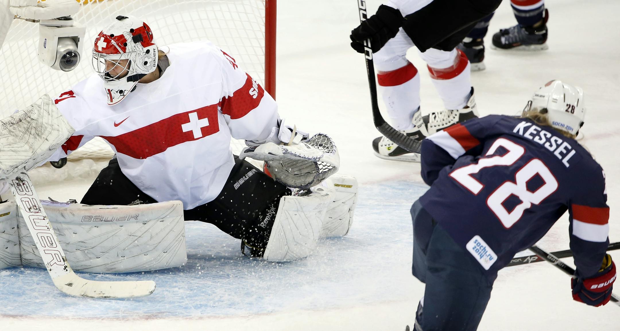 Amanda Kessel (28) shot the puck past Switzerland goalie Florence Schelling (41) in the first period. Kessel had two goals in the game. USA beat Switzerland by a final score of 9-0 at Shayba Arena on Monday.