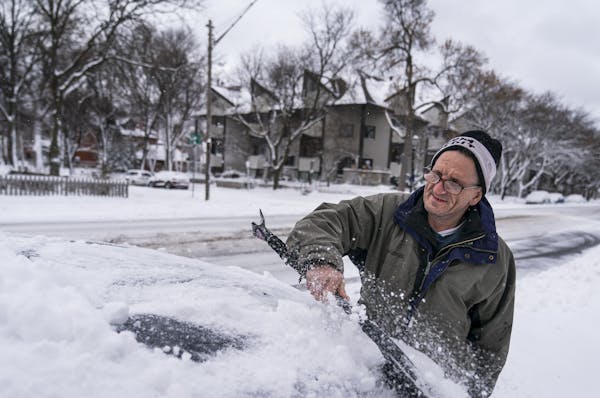Patrick Costanzo of St. Paul brushed snow off a friend's car on Selby Avenue in St. Paul. "I'm used to it," Costanzo said of the snow. "You never know