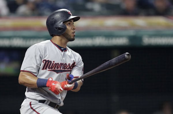 Minnesota Twins' Eddie Rosario watches his double off Cleveland Indians starting pitcher Carlos Carrasco during the fourth inning of a baseball game T