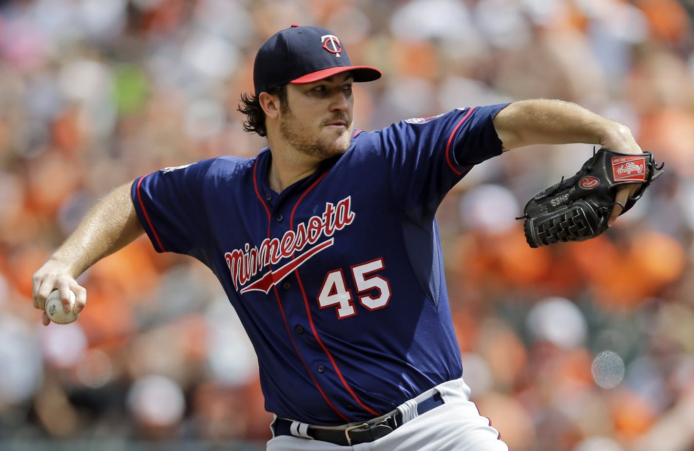 Minnesota Twins starting pitcher Phil Hughes throws to the Baltimore Orioles in the first inning of a baseball game, Monday, Sept. 1, 2014, in Baltimore.