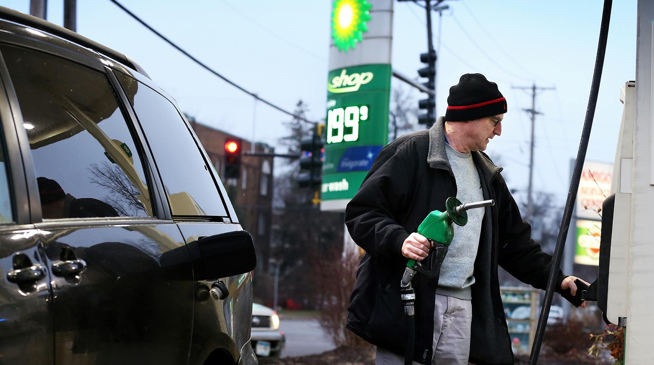 David Wiese of Minneapolis pumps gas at the BP gas station on Lyndale Avenue near W 36th Street in south Minneapolis, where the gas price dipped below $2.00 on Friday, December 26, 2014. "It's kind of amazing," said Wiese. "It's saving everybody lots of money." ] LEILA NAVIDI leila.navidi@startribune.com /