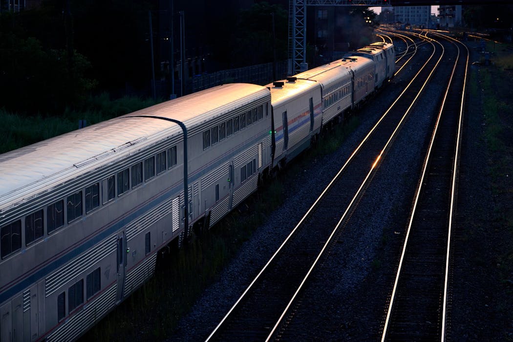 An Amtrak passenger train sits near Chicago's Union Station in the evening. (AP Photo/Charles Rex Arbogast)