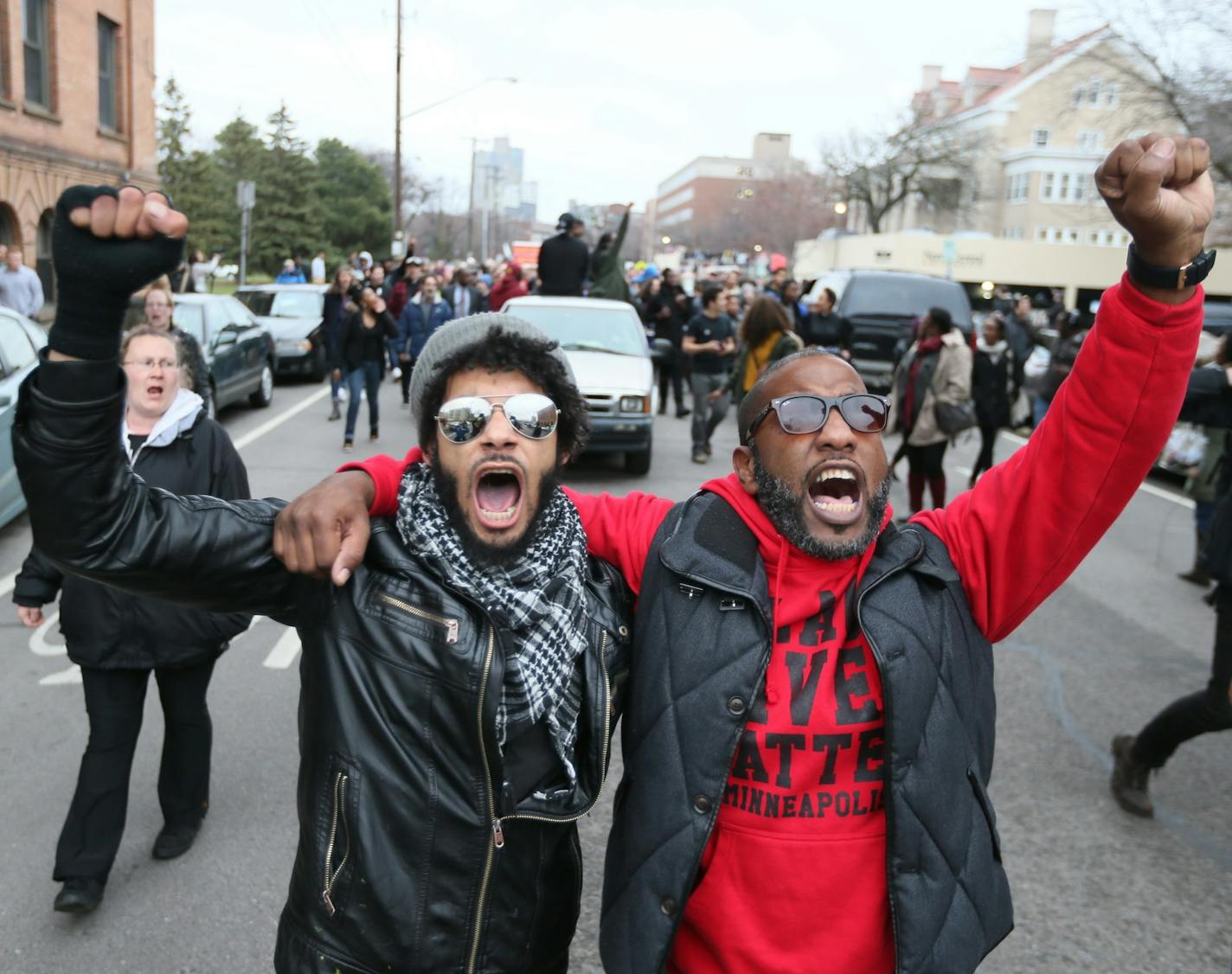 Jacob Ladda and Paster Danny Givens Elliot Park rally. ] RENEE JONES SCHNEIDER * reneejones@startribune.com Evening marches and protests began in Minneapolis on Wednesday, March 30, 2016 following the announcement that there will be no charges against Minneapolis police officers in the shooting death of Jamar Clark.