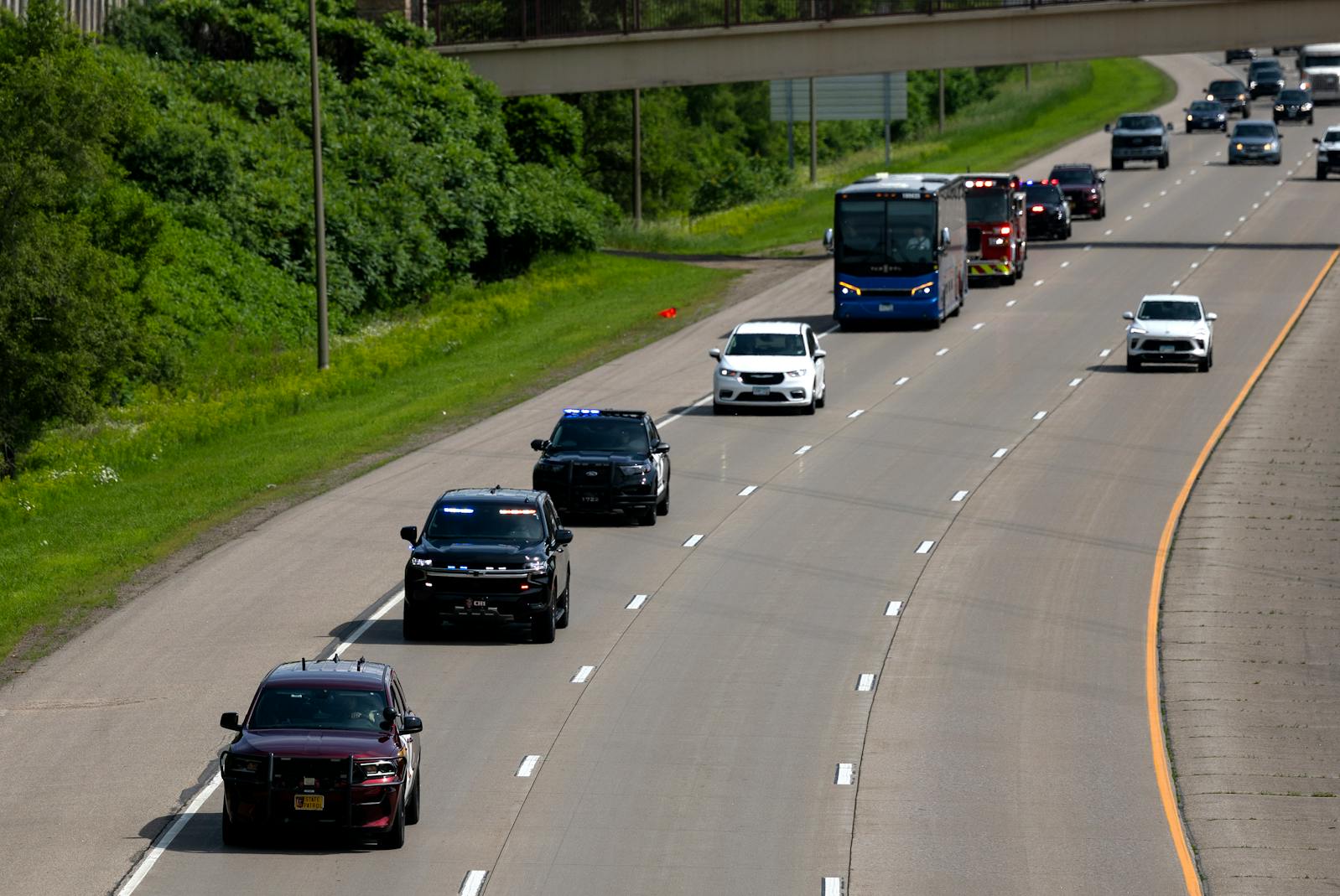 A processional to honor Melissa and Mark Hortman drives on I-494 passing Excelsior Boulevard in Minnetonka on Tuesday. 