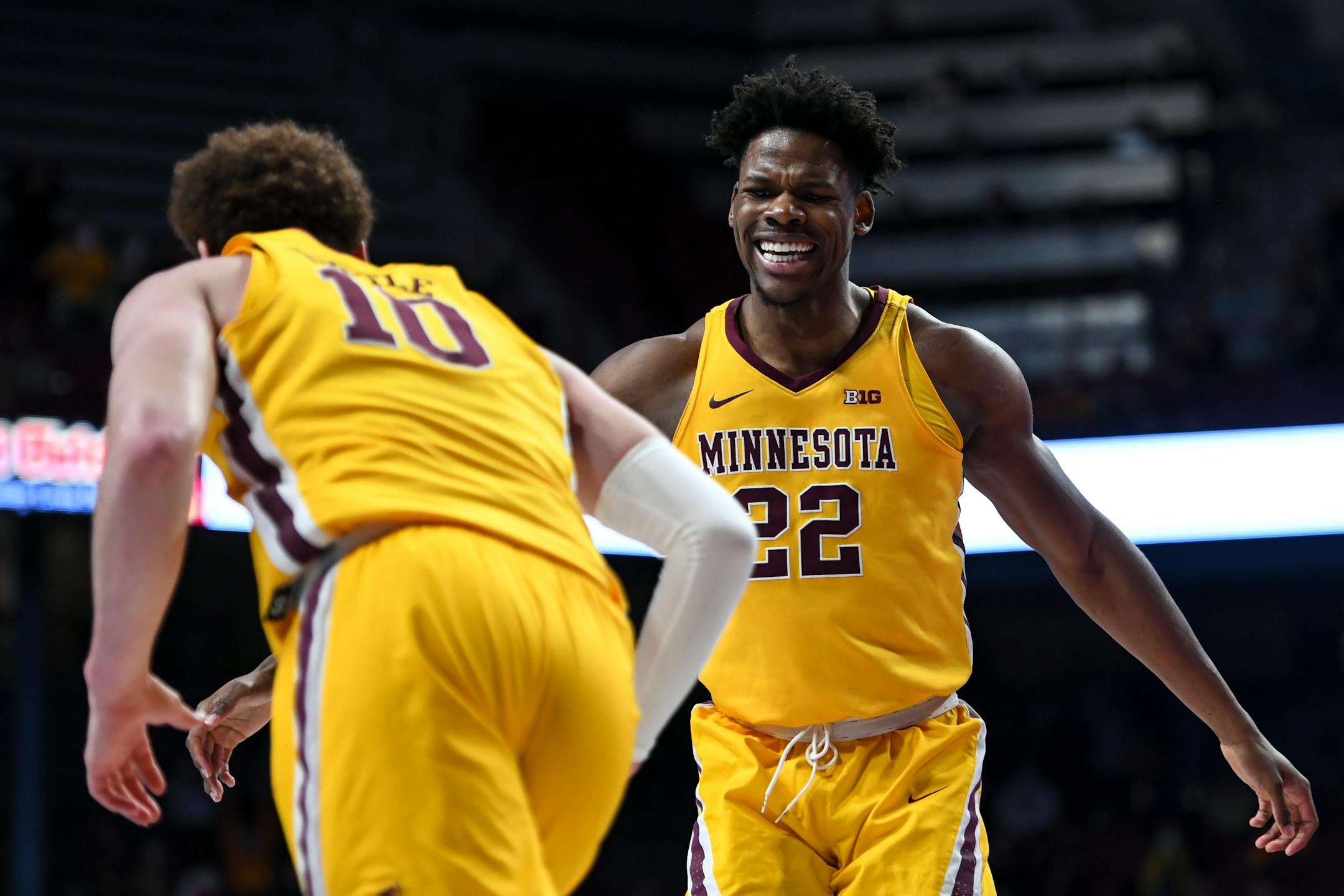Minnesota Gophers forward Danny Ogele (22) celebrates with forward Jamison Battle (10) after Battle dunked the ball during the first half of an NCAA men's basketball game between Minnesota and Purdue at Williams Arena in Minneapolis, Minn.