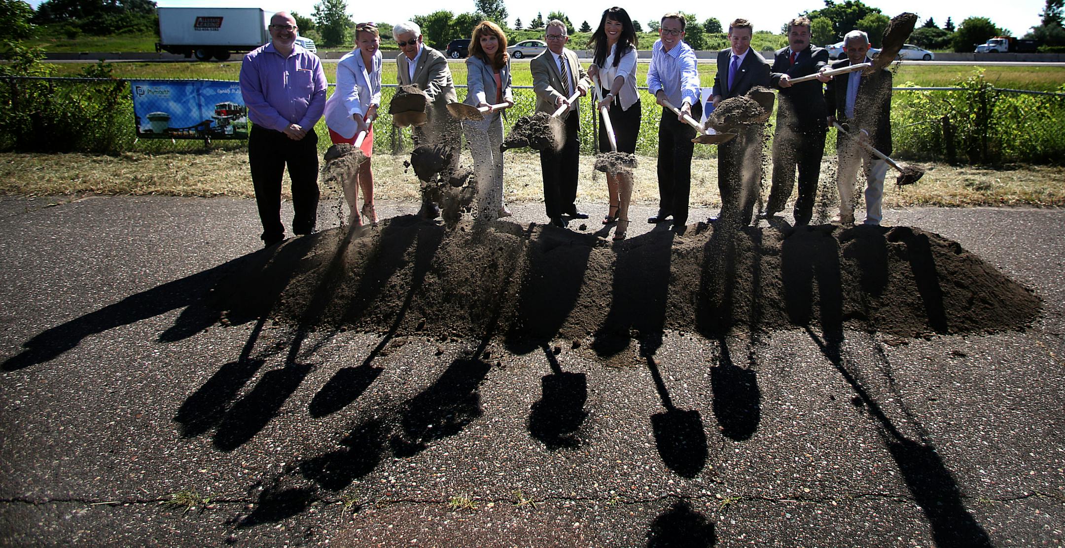 On a service road near the entrance to Begin Oaks Golf Course, Plymouth Mayor Kelli Slavik, fifth from right, and other dignitaries participated in a groundbreaking ceremony for the project.