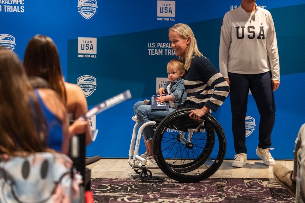 Mallory Weggemann, with daughter Charlotte, is announced as a member of the U.S. Paralympic swim team on Sunday at U.S. Bank Stadium.