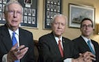 In this Nov. 9, 2017, photo, from left, Senate Majority Leader Mitch McConnell, R-Ky., Senate Finance Committee Chairman Orrin Hatch, R-Utah, and Trea