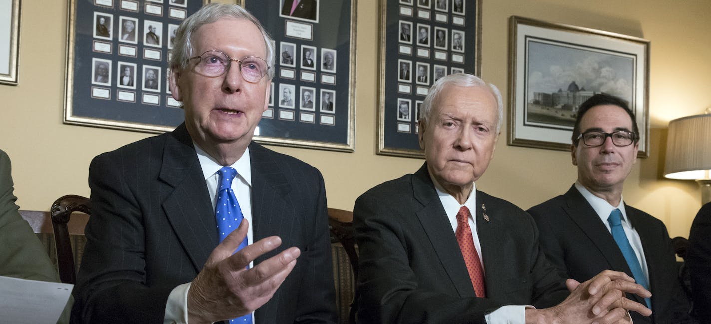 In this Nov. 9, 2017, photo, from left, Senate Majority Leader Mitch McConnell, R-Ky., Senate Finance Committee Chairman Orrin Hatch, R-Utah, and Treasury Secretary Steven Mnuchin, speak to reporters as work gets underway on the Senate's version of the GOP tax reform bill, on Capitol Hill in Washington. The House and Senate tax overhaul plans are broadly similar, but crucial differences create headaches for Republican leaders determined to keep myriad interest groups and factions of the GOP sati