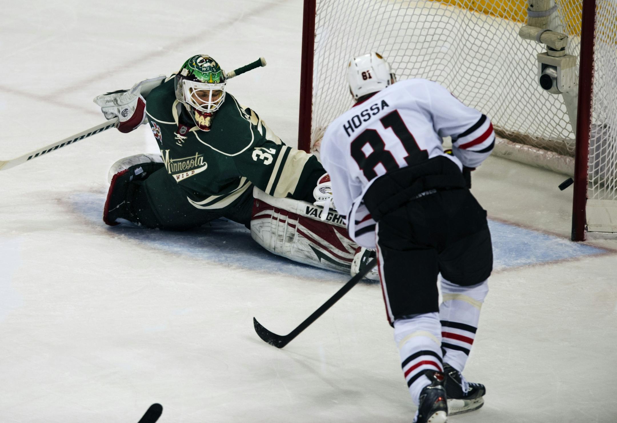 Blackhawk Marian Hossa knocks in his short handed goal near the end of the third period. Wild goalie Niklas Backstrom watches.