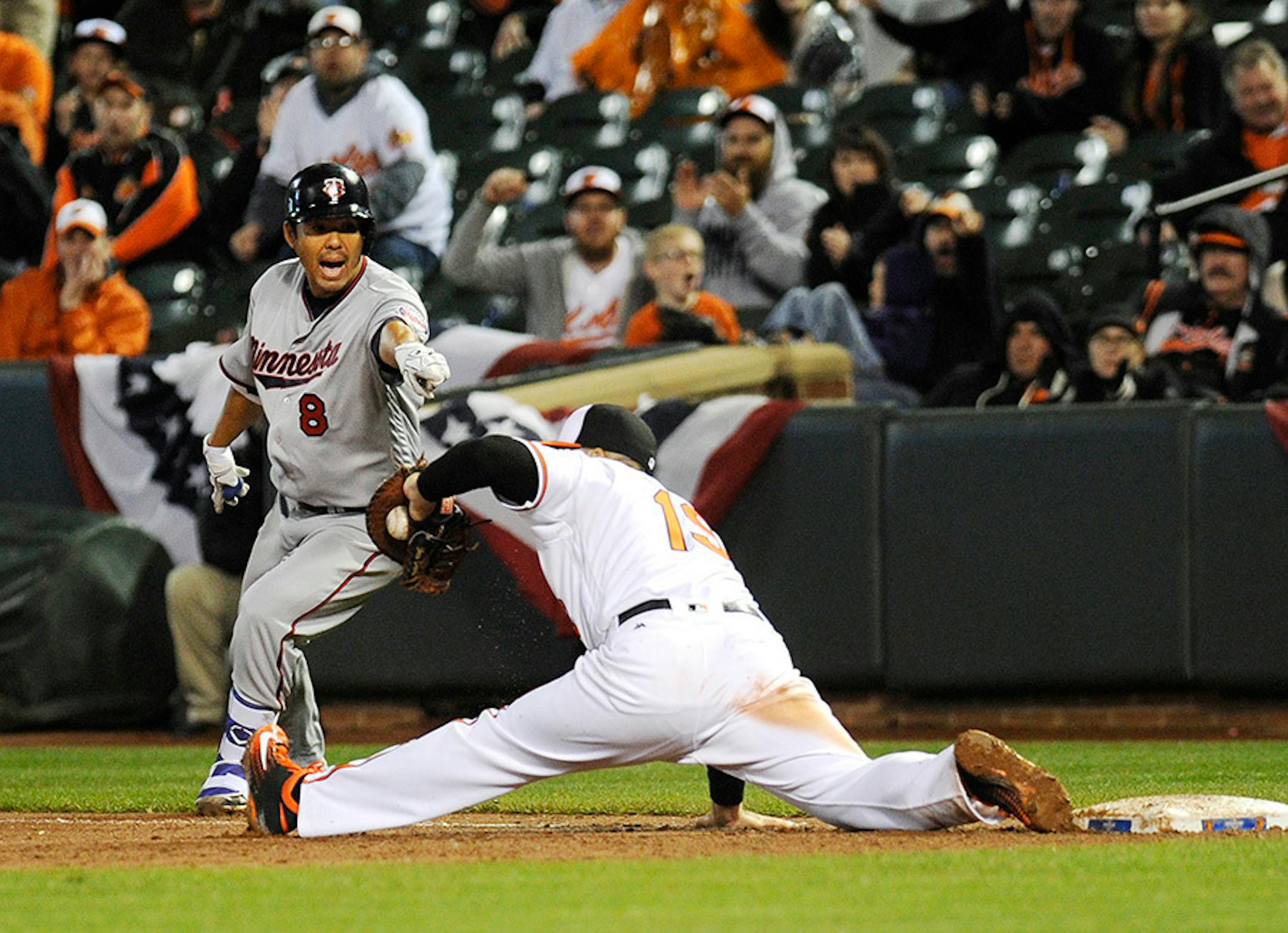 Baltimore Orioles first baseman Chris Davis makes a catch to get the final out of the ninth inning against Minnesota Twins' Kurt Suzuki on Monday, April 4, 2016, at Oriole Park at Camden Yards in Baltimore.