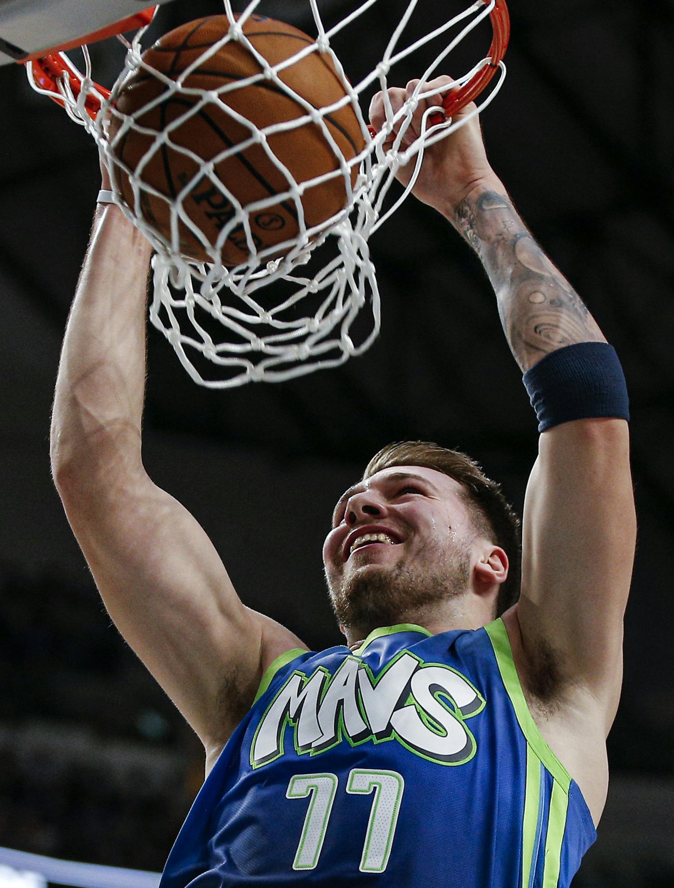 Dallas Mavericks forward Luka Doncic dunks during the first half of an NBA basketball game against the San Antonio Spurs, Thursday, Dec. 26, 2019, in Dallas. (AP Photo/Brandon Wade)