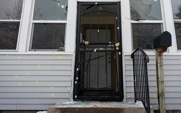 Bullet holes marked the front of the house on N. Thomas Avenue in Minneapolis, the scene of an officer-involved shooting Sunday that killed a man.