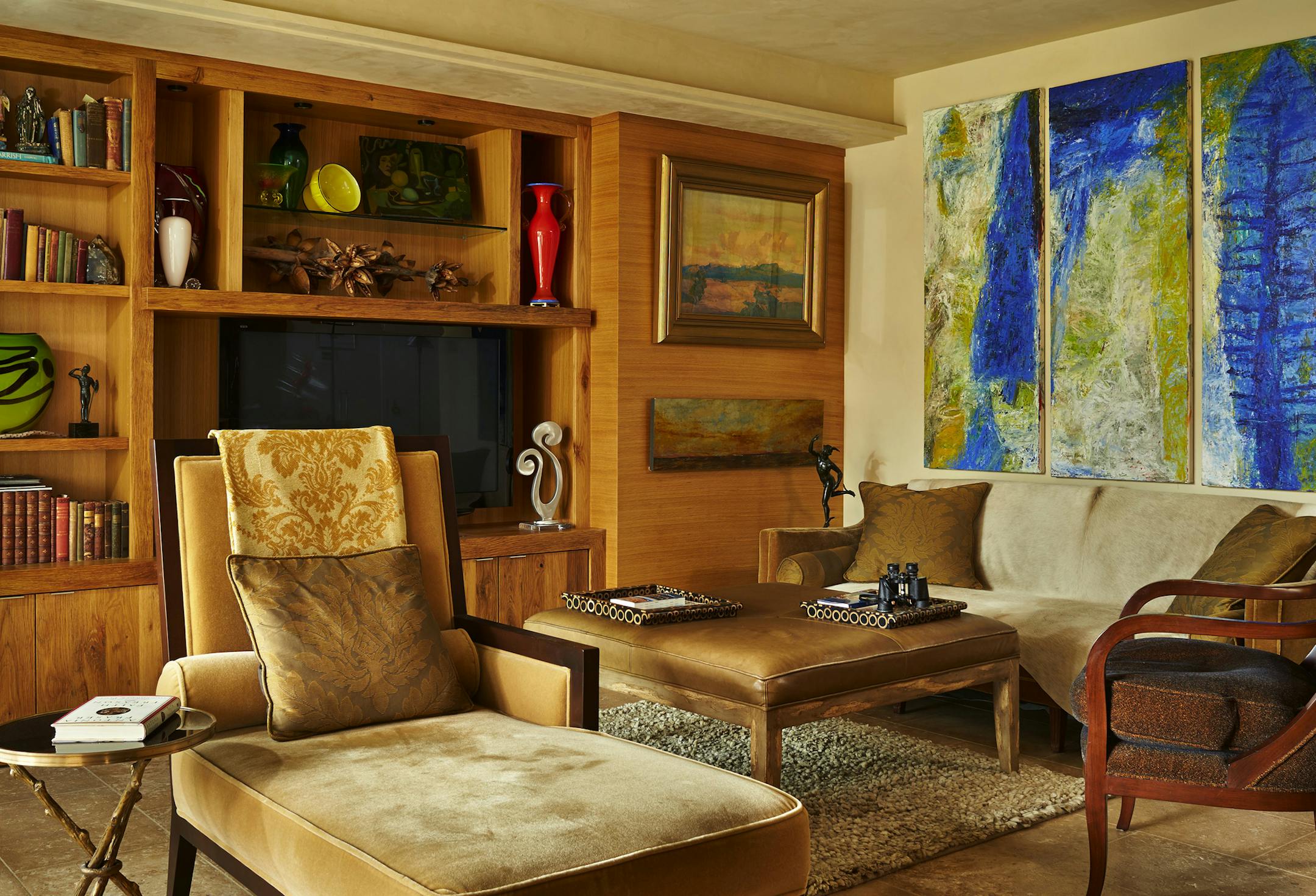 "We wanted it to look nice because it's our grown-up space," says Vickie Maloney of the couple's downtown condo. They had the sofa, a consignment piece purchased at Modele's Home Furnishings, re-covered in mohair. The cabinetry is oak, and the floor is limestone. Artwork over the sofa is by Sylvain Klaus. (Benjamin Benschneider/Seattle Times/TNS) ORG XMIT: 1161558