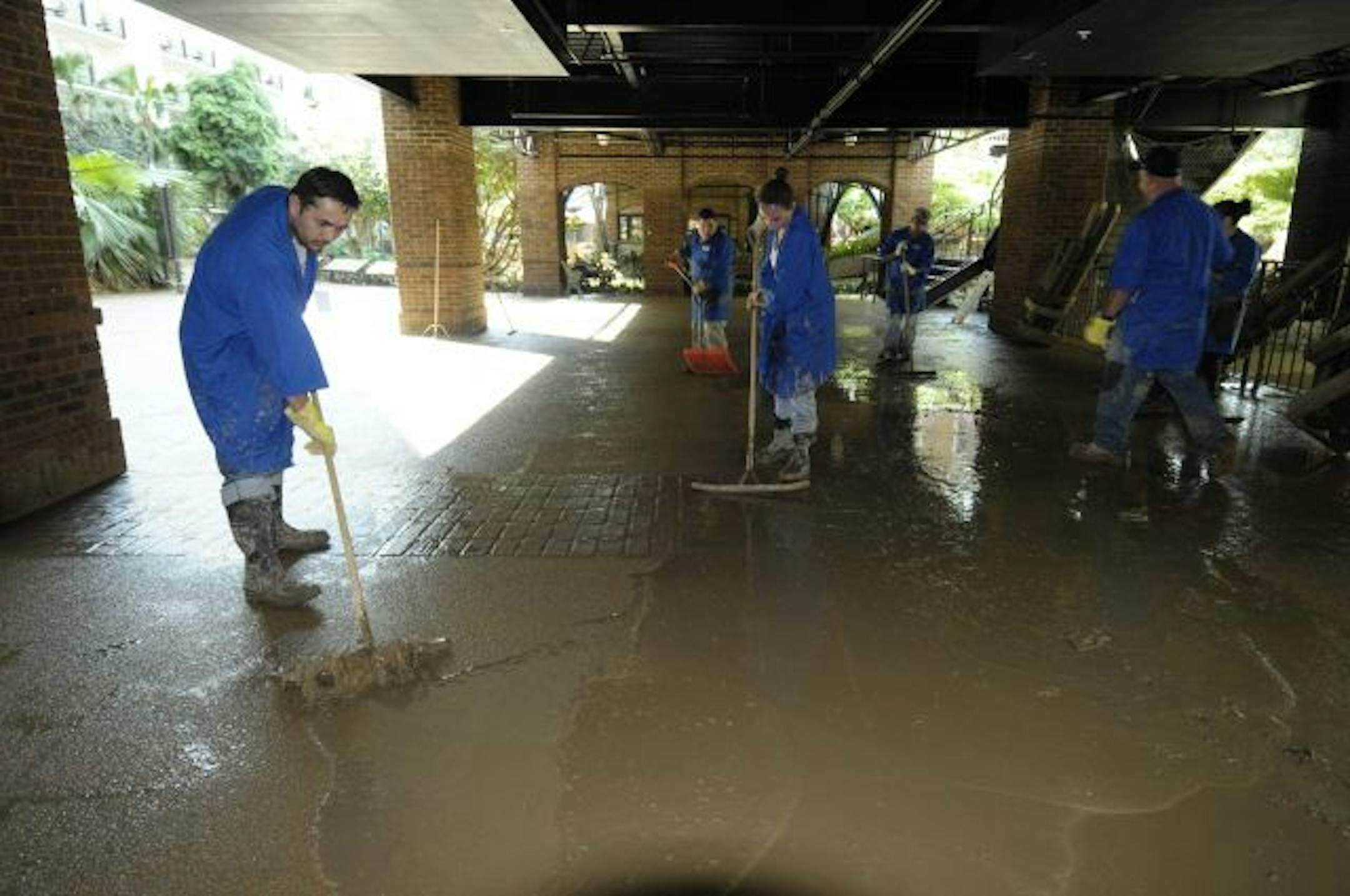 In a May 6, 2010 photo provided by Gaylord Entertainment, workers mop and squeegee water from an entrance of the Gaylord Opryland Resort in Nashville., which is damaged from floodwaters. The resort won't be taking bookings from now through October after it was flooded under as much as 10 feet of water.