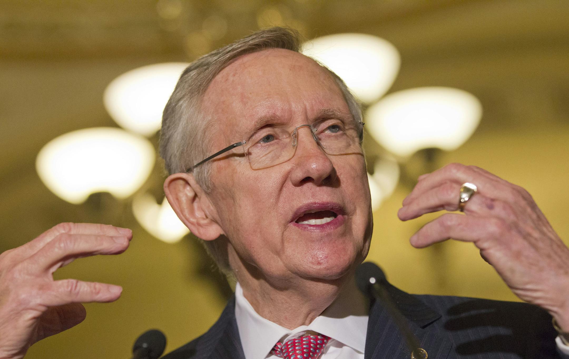 Senate majority leader Harry Reid gestures as he speaks to the media as lawmakers moved toward resolving their feud over filibusters of White House appointees on Capitol Hill in Washington, Tuesday, July 16, 2013.