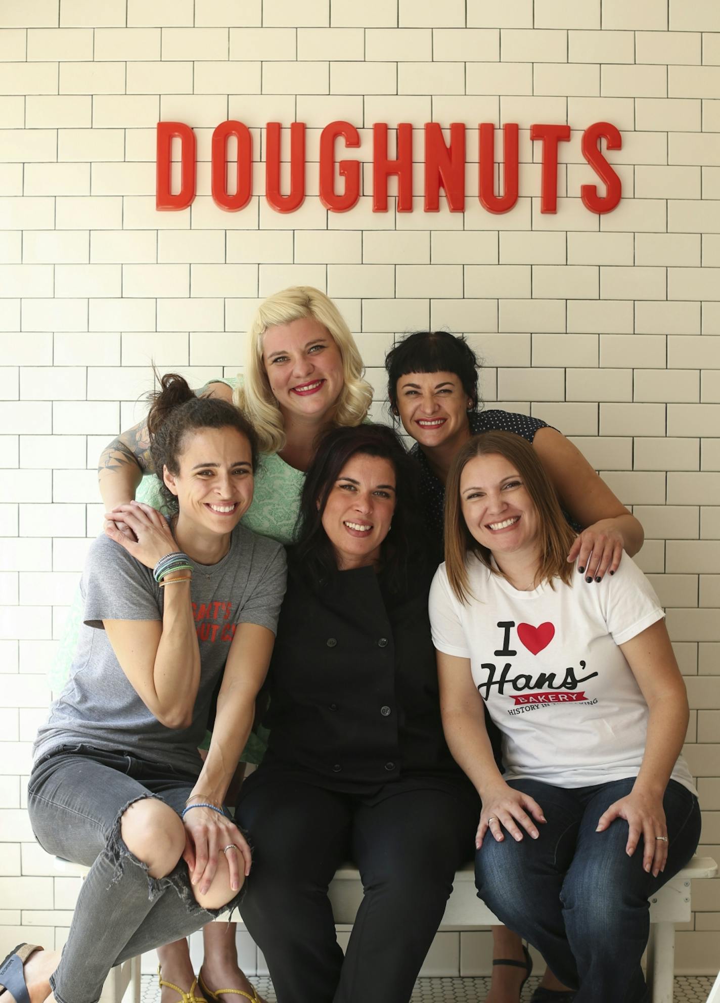 These five women have taken the Twin Cities doughnut scene to new levels. Front row, from left: Anne Rucker of Bogart's Doughnut Co., Lisa Clark of Mojo Monkey Donuts and Kelly Olsen of Hans' Bakery. Back row (from left): Teresa Fox and Arwyn Birch of Glam Doll Donuts.