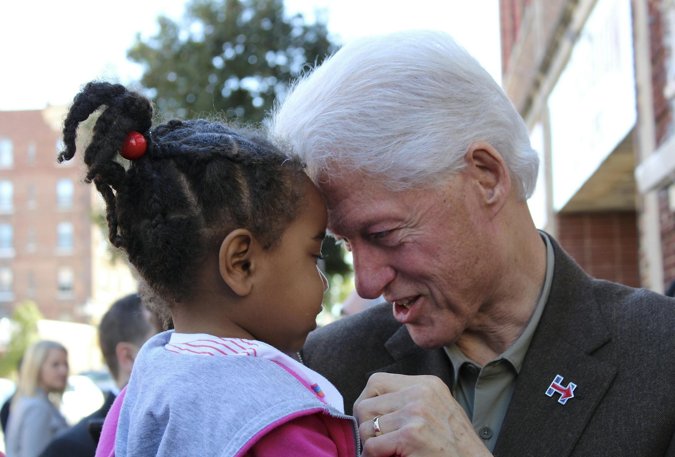 Former President Bill Clinton holds 3-year-old Jakiera Dupree while campaigning for Democratic presidential nominee Hillary Clinton in Wilson, N.C., on Tuesday, Oct. 25, 2016. (Corey Friedman/The Wilson Times via AP)