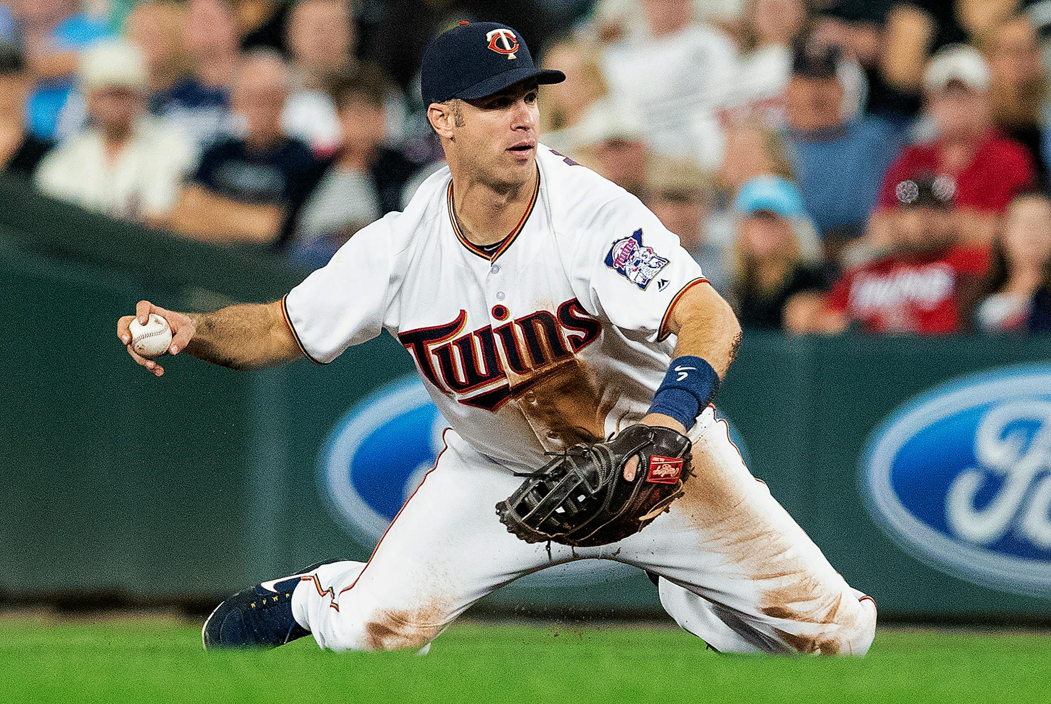 Twins first baseman Joe Mauer fielded a ball in the fifth inning.