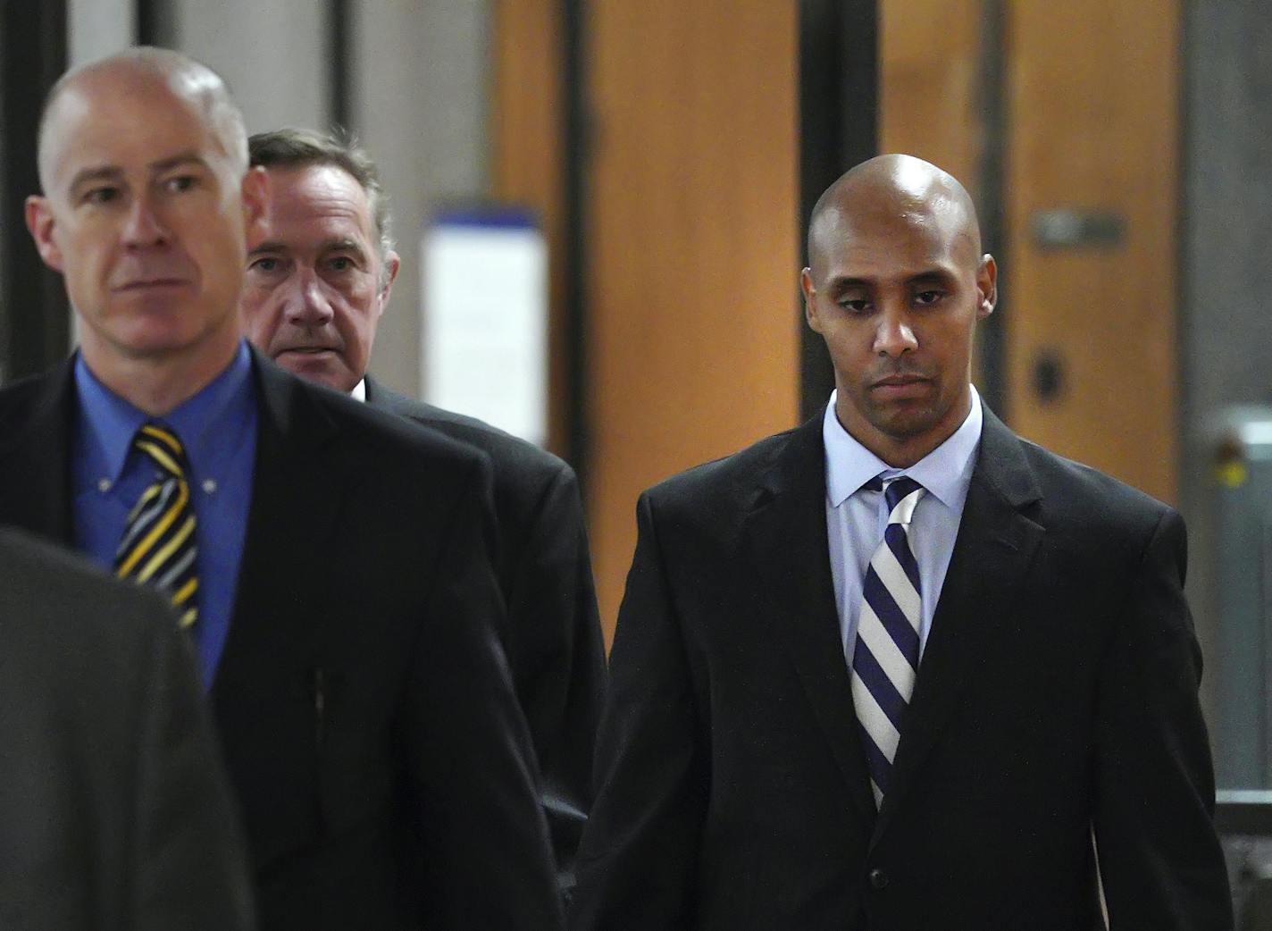 Former Minneapolis police officer Mohamed Noor, right, with attorneys Peter Wold, center, and Thomas Plunkett, left, walks out of the the Hennepin County Government Center Thursday, April 25, 2019, in Minneapolis. Noor refused to talk to investigators after the July 2017 shooting of Justine Ruszczyk Damond, a dual citizen of the U.S. and Australia, making his testimony his first public statements since her death. (Brian Peterson/Star Tribune via AP)