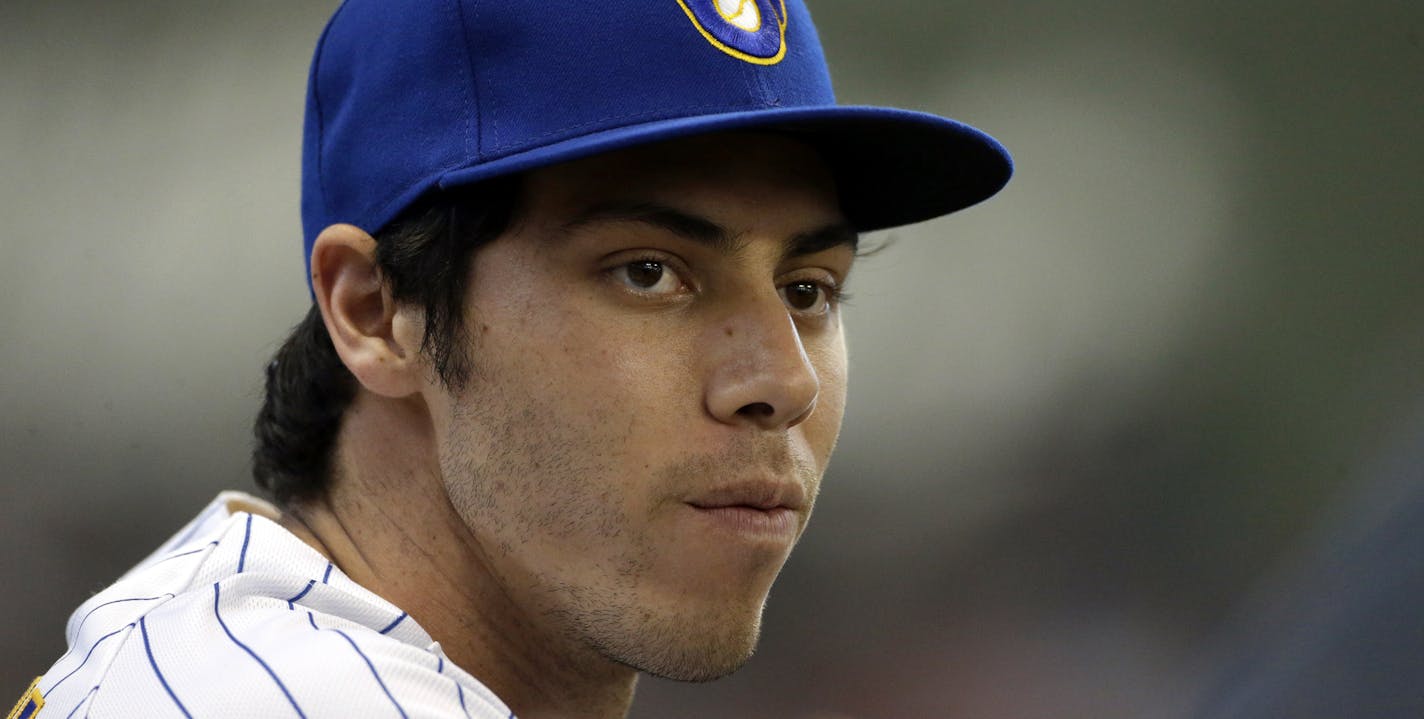 Milwaukee Brewers' Christian Yelich sits in the dugout before a baseball game against the Philadelphia Phillies Friday, May 24, 2019, in Milwaukee. (AP Photo/Aaron Gash)