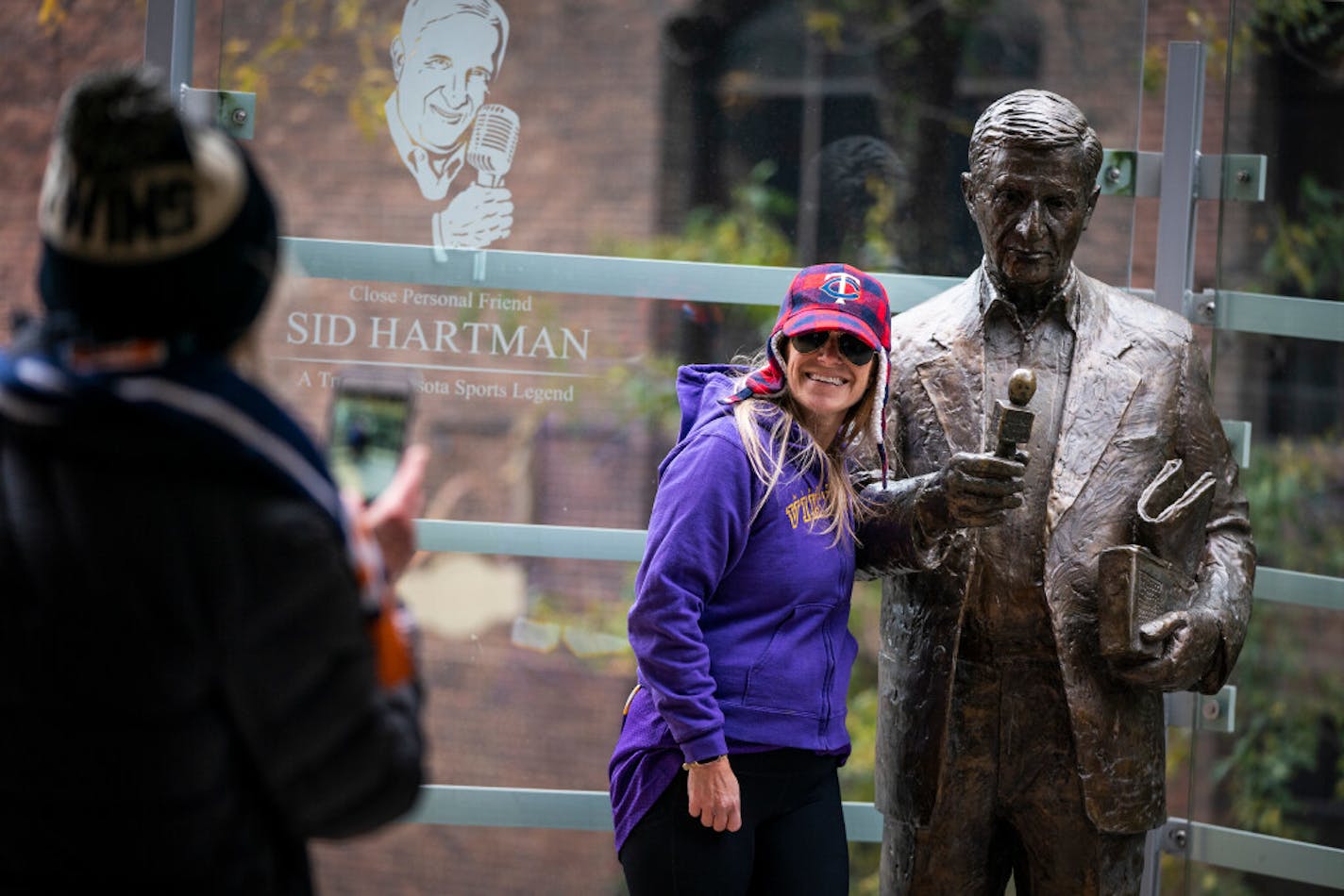 Emily Clausman of Minneapolis had her photo taken by her mother Cheryle Clausman with the statue of Sid Hartman at Target Center in downtown Minneapolis. "I've been listening to and watching him for many years," said Emily, who made the trip to the statue with her mother after they heard Sid had died. "He was my hero for his work ethic. ... He brought sports to life."