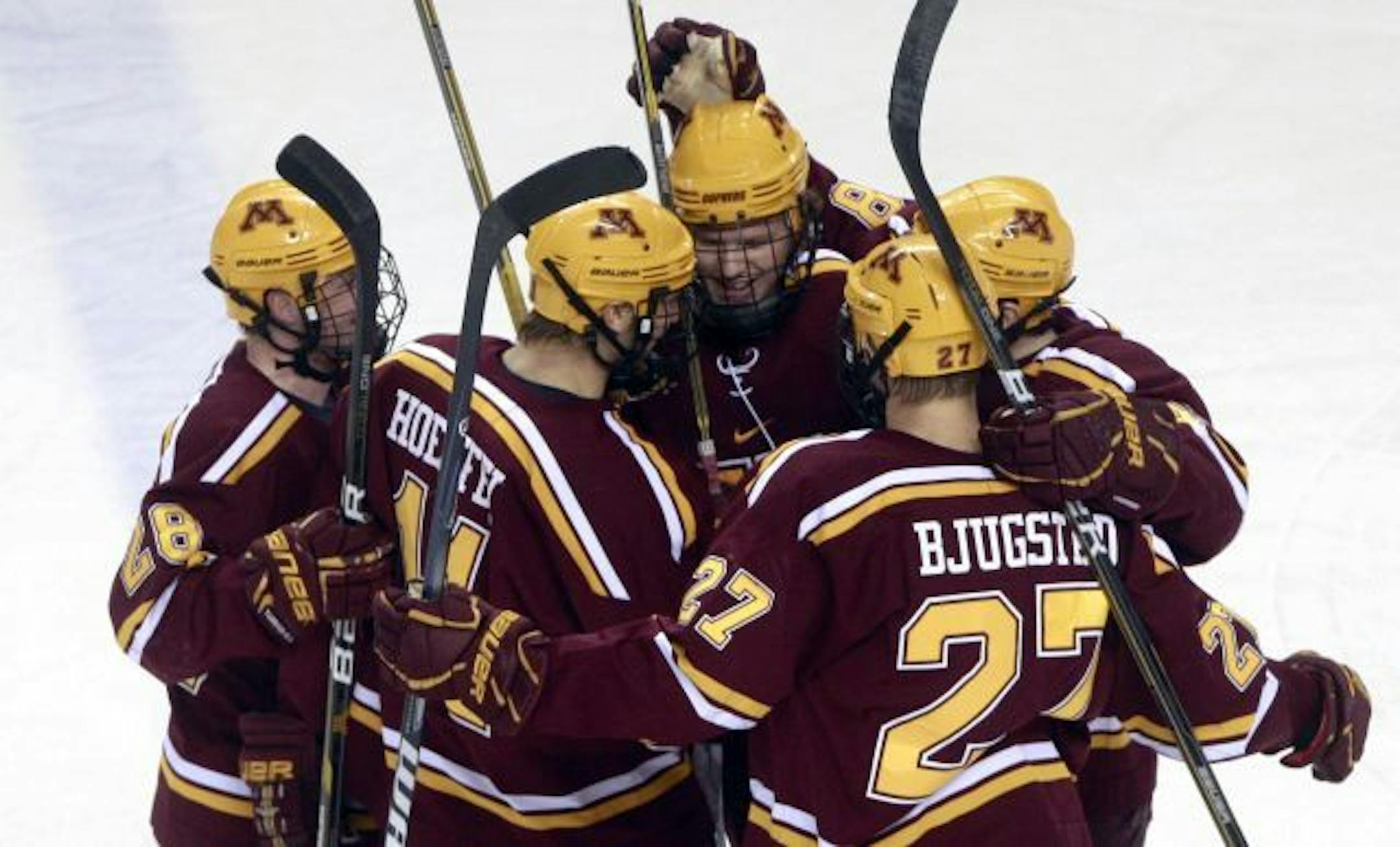 Minnesota players celebrate their first goal against North Dakota during an NCAA college hockey game, Friday, Jan. 14, 2011, in Grand Forks, N.D.