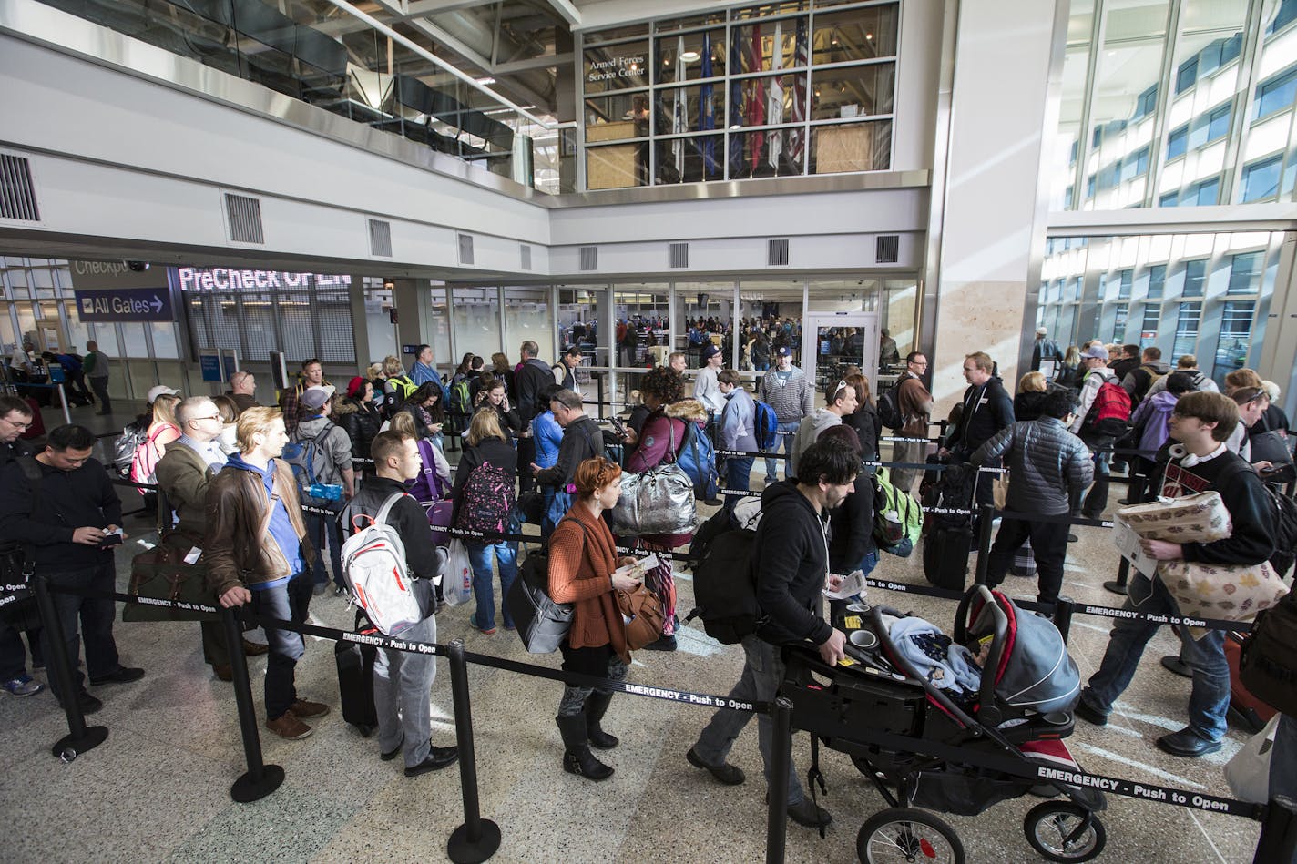 Passengers wait in line to go through the new north security checkpoint at Terminal 1 of Minneapolis-St. Paul International Airport. ] (Leila Navidi/Star Tribune) leila.navidi@startribune.com BACKGROUND INFORMATION: Friday, February 26, 2016 at Terminal 1 of Minneapolis-St. Paul International Airport.