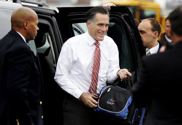 Republican presidential candidate, former Massachusetts Gov. Mitt Romney gets out of his vehicle before boarding his campaign plane at Toledo Express 