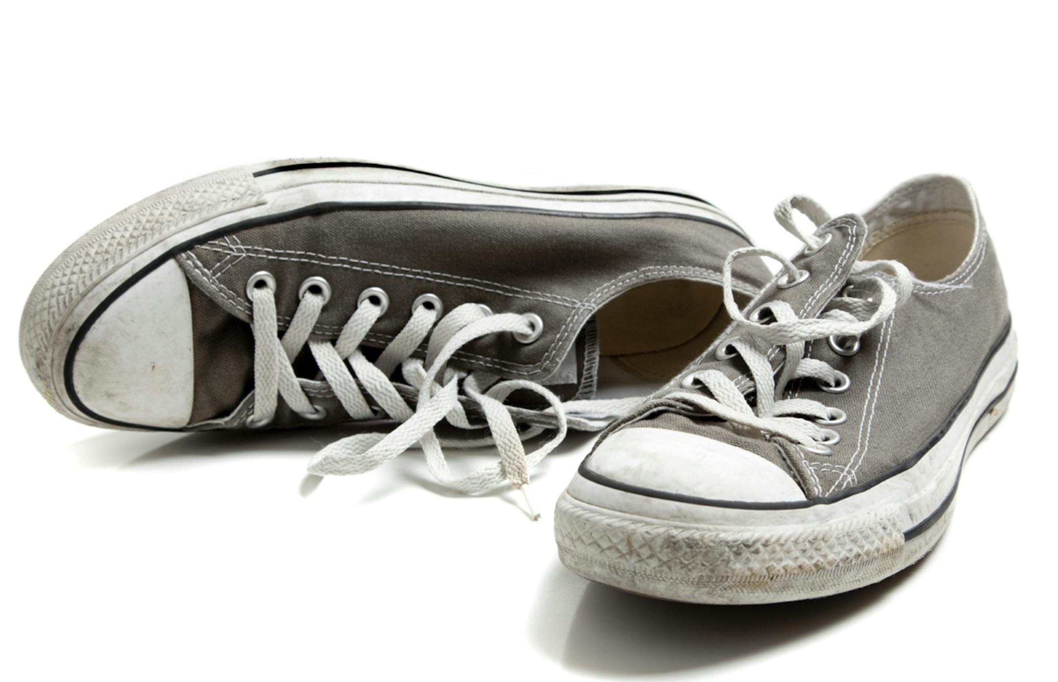 A pair of grey sneakers on white