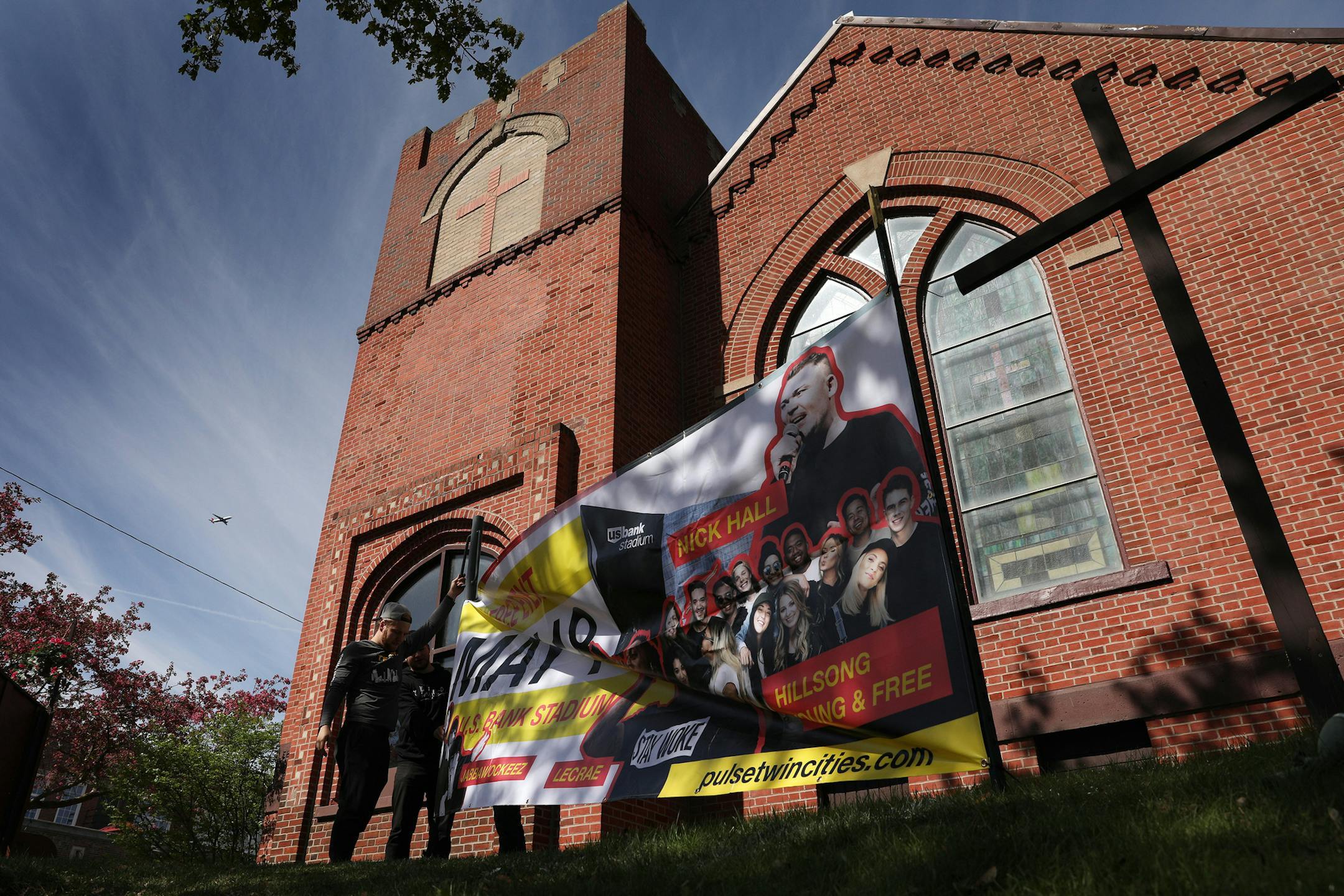 Matt Throne, Mark Warder, and Andross Martinson with the Pulse Twin Cities' install team put up a large banner promoting their upcoming event Thursday at Lebanon Lutheran Church. ] ANTHONY SOUFFLE ï anthony.souffle@startribune.com Mark Warder, Matt Throne, and Andross Martinson with the Pulse Twin Cities' install team put up a large banner promoting their upcoming event Thursday, May 10, 2018 at Lebanon Lutheran Church in Minneapolis.