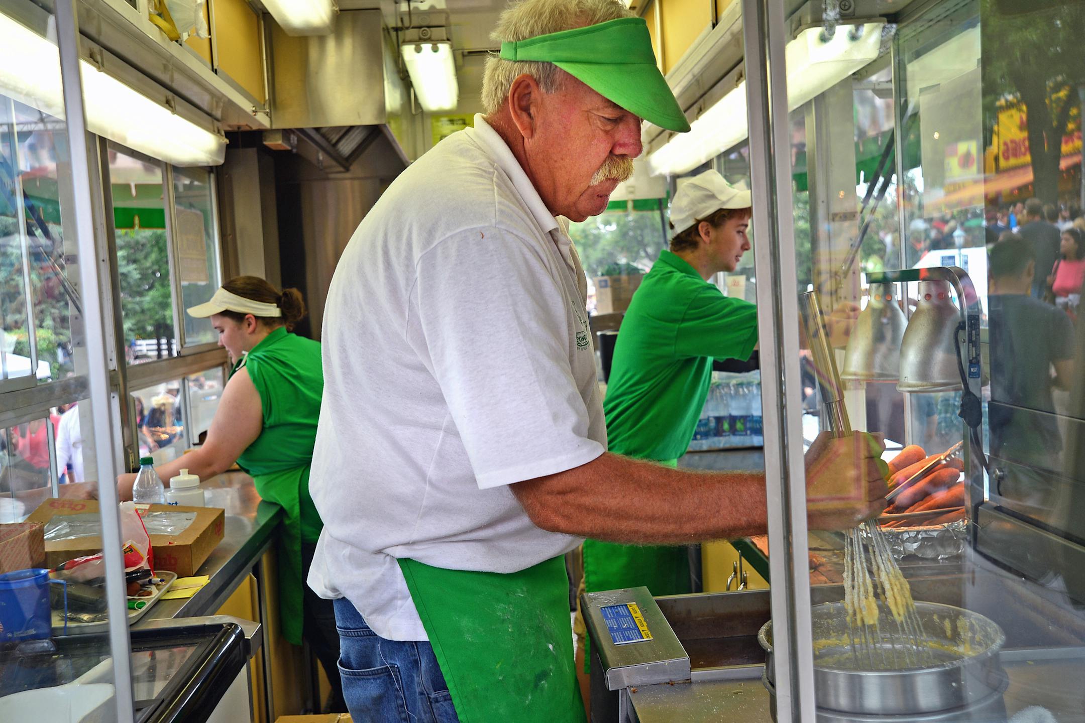 Did fair attendance rebound enough to save businesses was one of the questions that hung in the air on the last day of the Minnesota Stater Fair. Chuck Johnson stirred the batter getting ready to make some Poncho Dogs on a stick. He has worked at the fair serving food for 48 years. ] Richard.Sennott@startribune.com Richard Sennott/Star Tribune Falcon Heights Minnesota Monday 9/2/13) ** (cq)