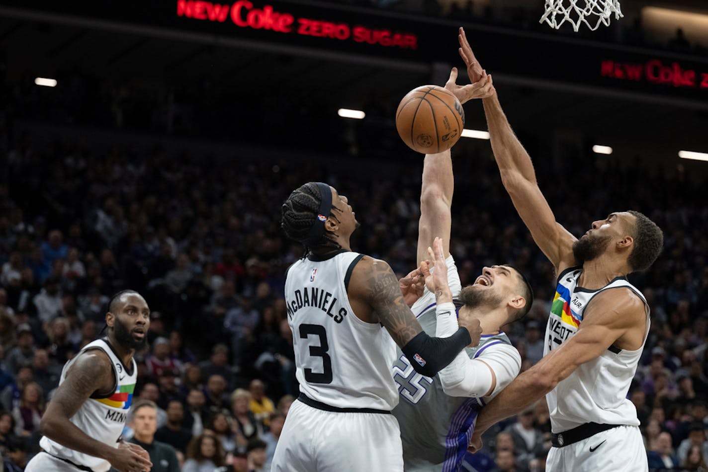 Minnesota Timberwolves center Rudy Gobert and forward Jaden McDaniels (3) defend Sacramento Kings center Alex Len (25) in the second half of an NBA basketball game in Sacramento, Calif., Monday, March 27, 2023. The Timberwolves won 119-115. (AP Photo/José Luis Villegas)