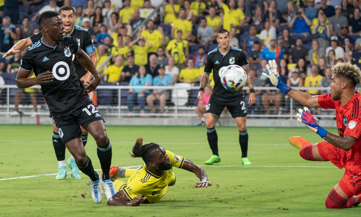 Minnesota United goalkeeper Dayne St. Clair (97) defends the goal as Nashville SC forward C.J. Sapong (17) attacks past Minnesota United defender Bakaye Dibassy (12) during the first half of an MLS soccer match at Geodis Park, Sunday, Aug. 14, 2022, in Nashville, Tenn. (George Walker IV/The Tennessean via AP)