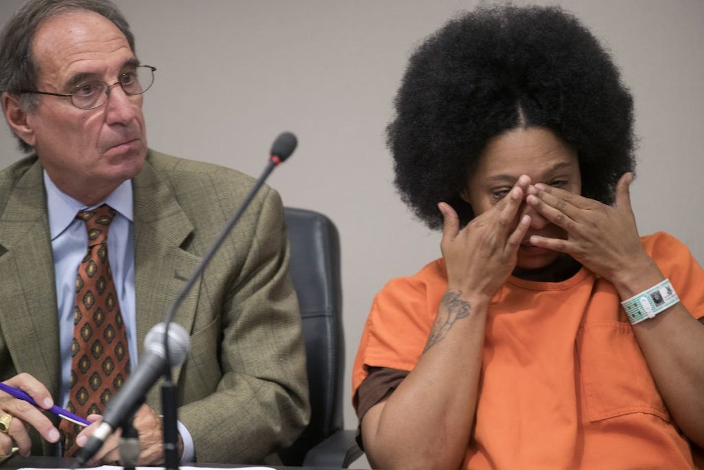 Beverly Burrell, with her attorney Craig Cascarano at her side wiped her eye as she listened to a victim impact statement. She was later sentenced to 14 years for the overdose deaths of two men Thursday September 28,2017 in Minneapolis.