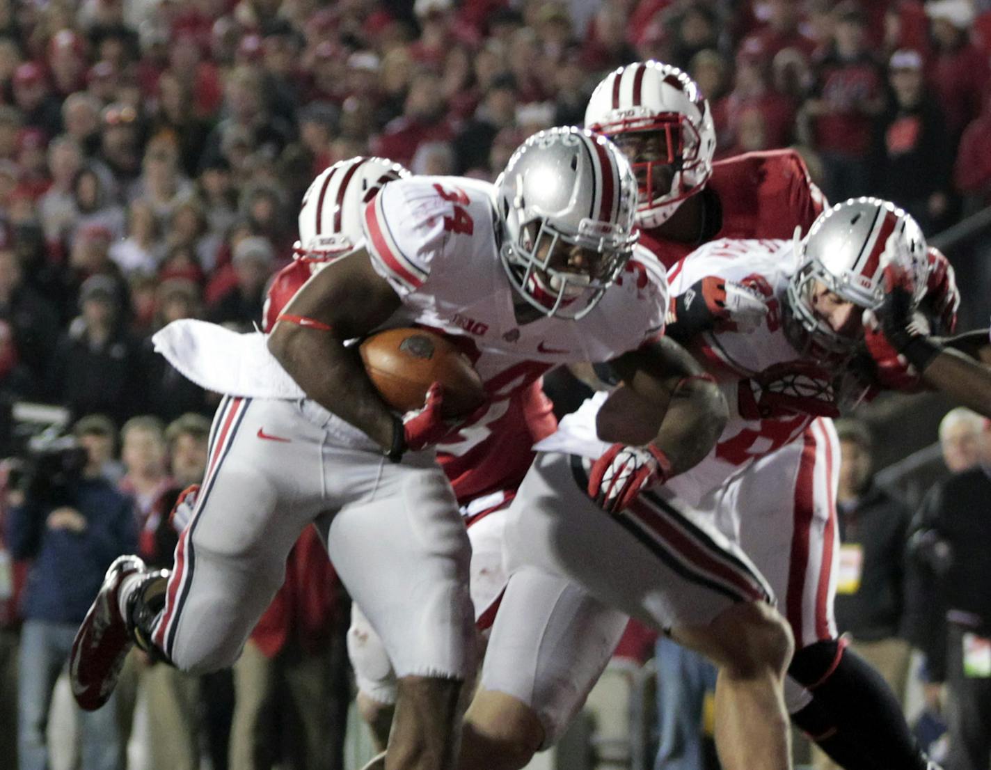 Ohio State running back Carlos Hyde scores the game-winning touchdown against Wisconsin in overtime of an NCAA college football game, Saturday, Nov. 17, 2012, in Madison, Wis. Ohio State won 21-14. (AP Photo/Andy Manis)