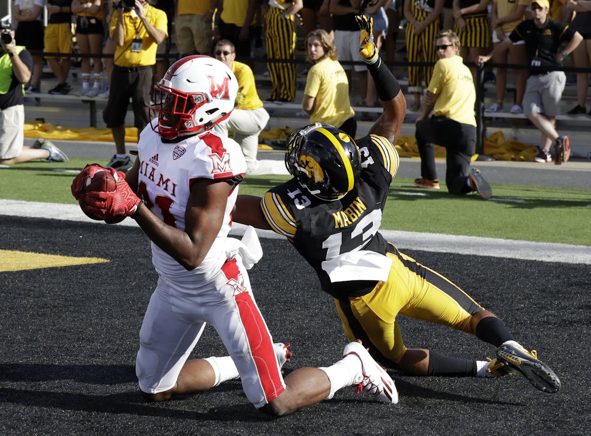 FILE - In this Saturday, Sept. 3, 2016, file photo, Miami of Ohio wide receiver James Gardner catches a touchdown pass as Iowa defensive back Greg Mab