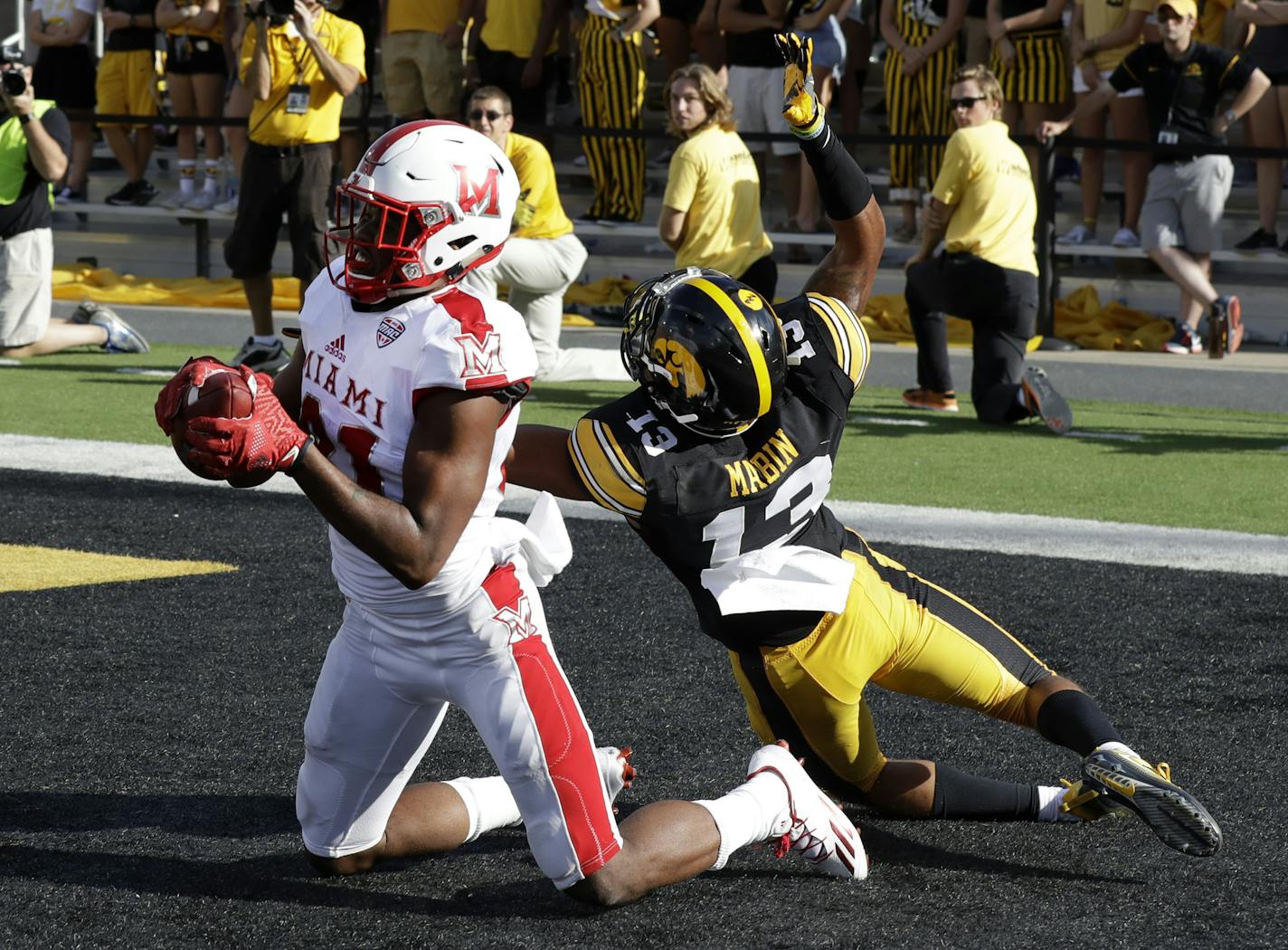 FILE - In this Saturday, Sept. 3, 2016, file photo, Miami of Ohio wide receiver James Gardner catches a touchdown pass as Iowa defensive back Greg Mabin tried to defend during the second half of an NCAA college football game in Iowa City, Iowa. So much for the notion that the St. Petersburg Bowl is just another lower-tier postseason matchup featuring teams with mediocre records and little to accomplish, even by winning. However, the Bulldogs and RedHawks are taking the game seriously. (AP Photo/